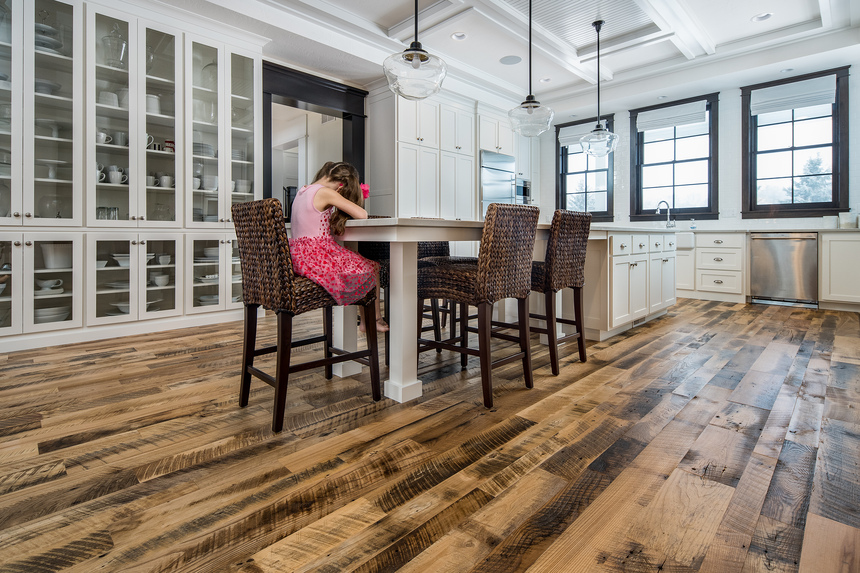 Girl sitting at table on reclaimed floor