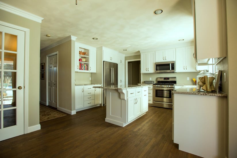 Paint is often used on kitchen cabinets to provide a contrast with the hardwood floor colors.