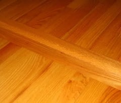 A hardwood floor crosspiece is ideal for separating areas in an open floorplan.